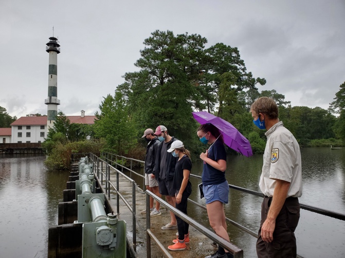 A group of people standing on a bridge AI-generated content may be incorrect.