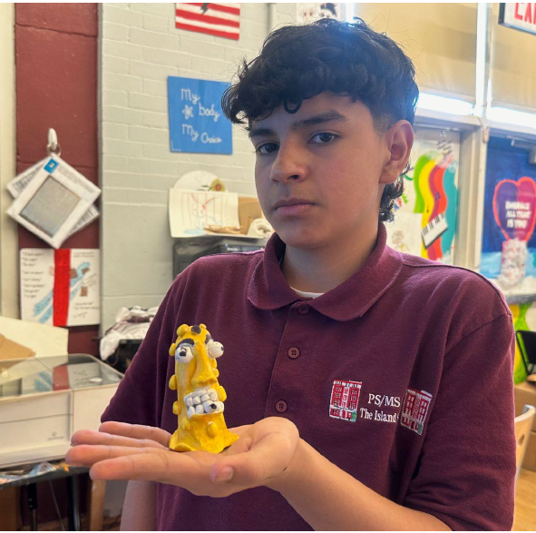 A child holding a yellow sculpture AI-generated content may be incorrect.