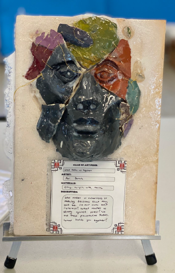 A piece of art with a piece of paper AI-generated content may be incorrect.